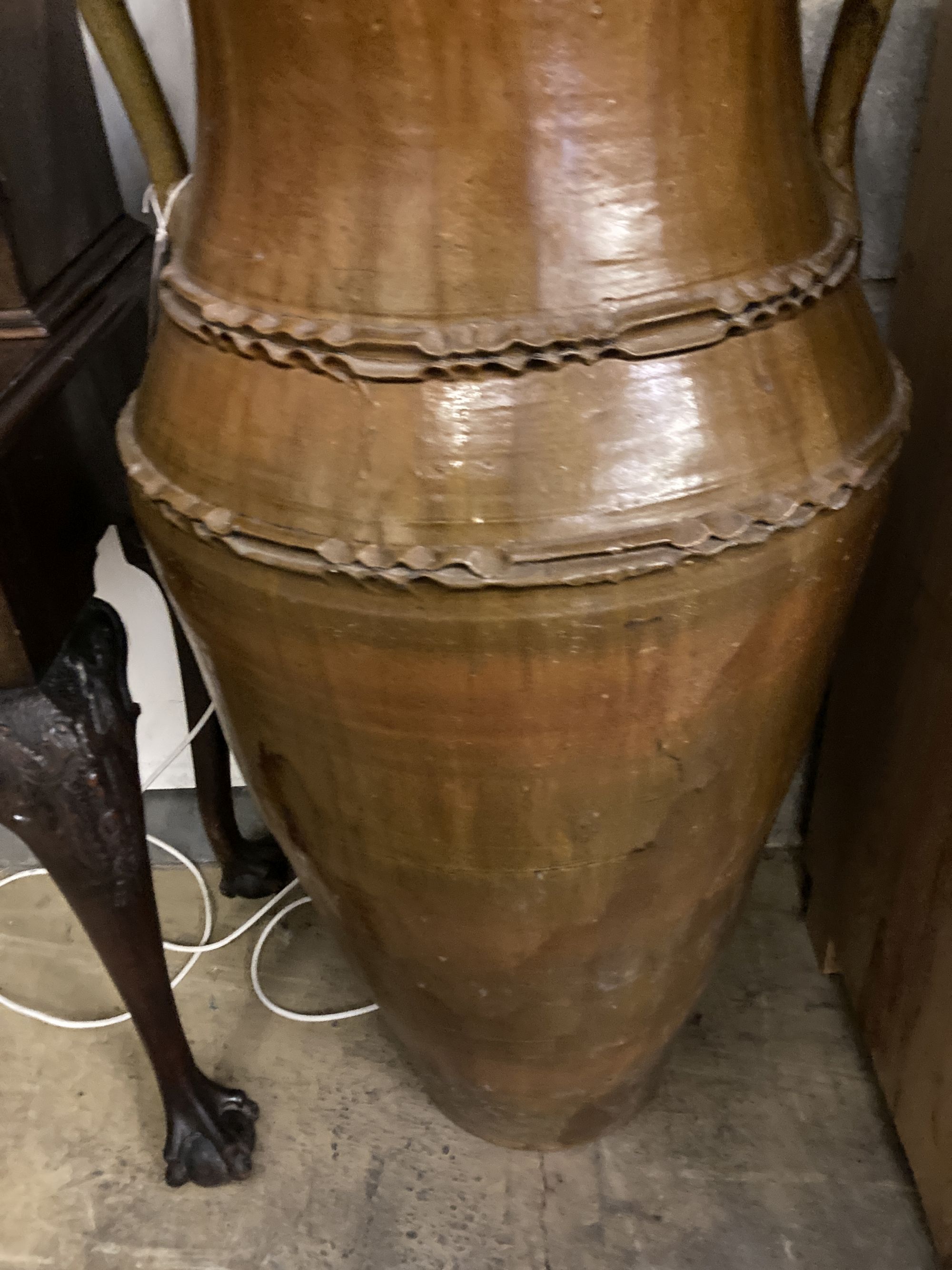 A Portuguese two-handled pottery oil jar, of waisted tapered ovoid form, height 105cm